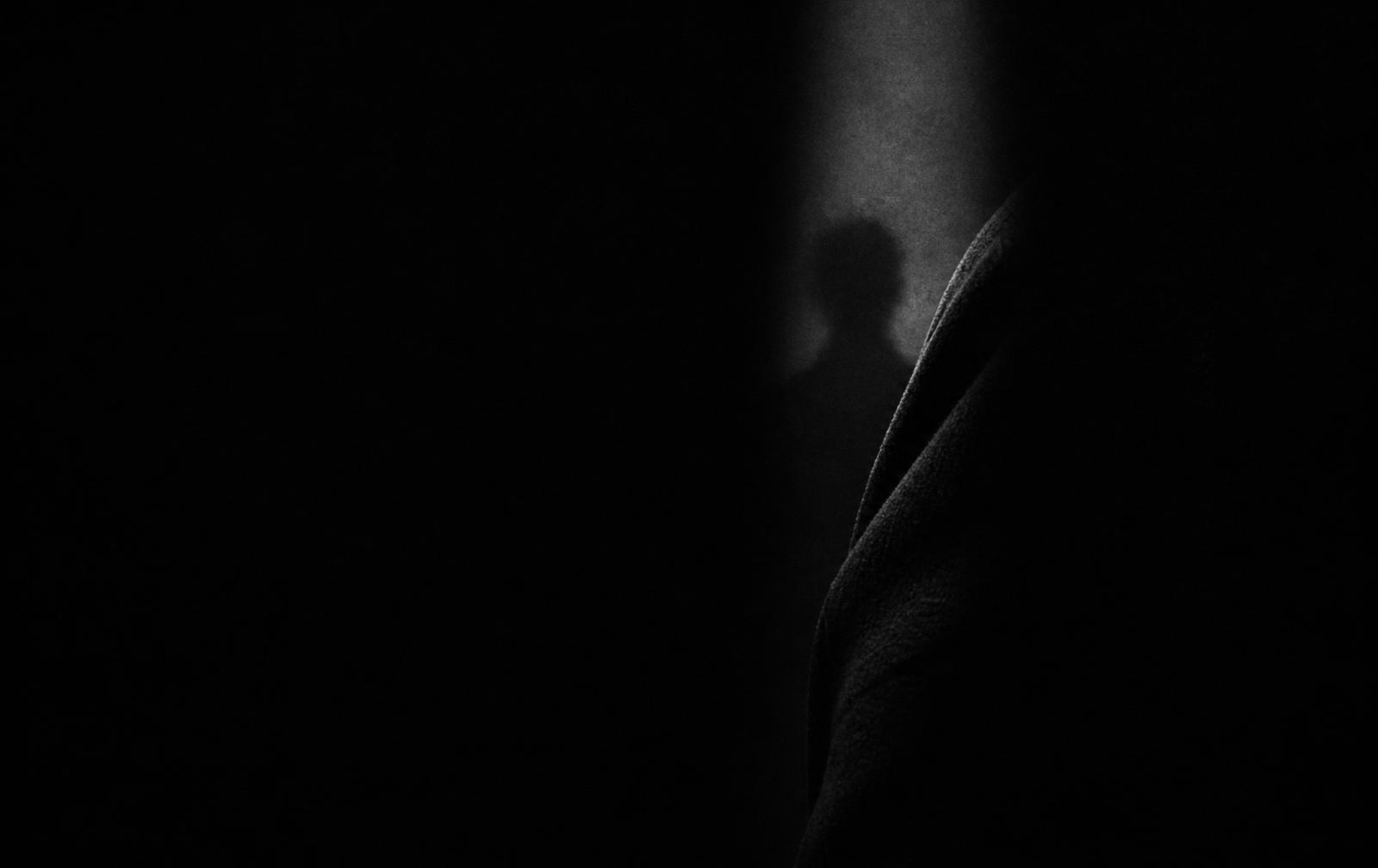 A sliver of light revealing cropped dark fabric